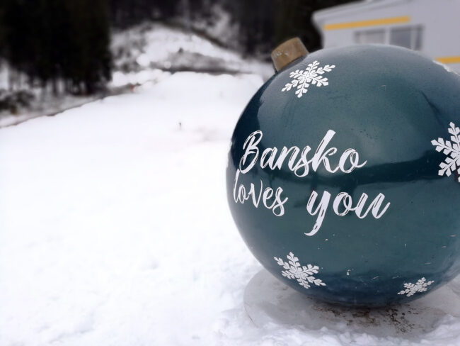 Bansko loves you Christmas ornament overlooking winter mountain landscape