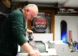 Technician tuning skis at Ski and Board Traventuria service center in Bansko