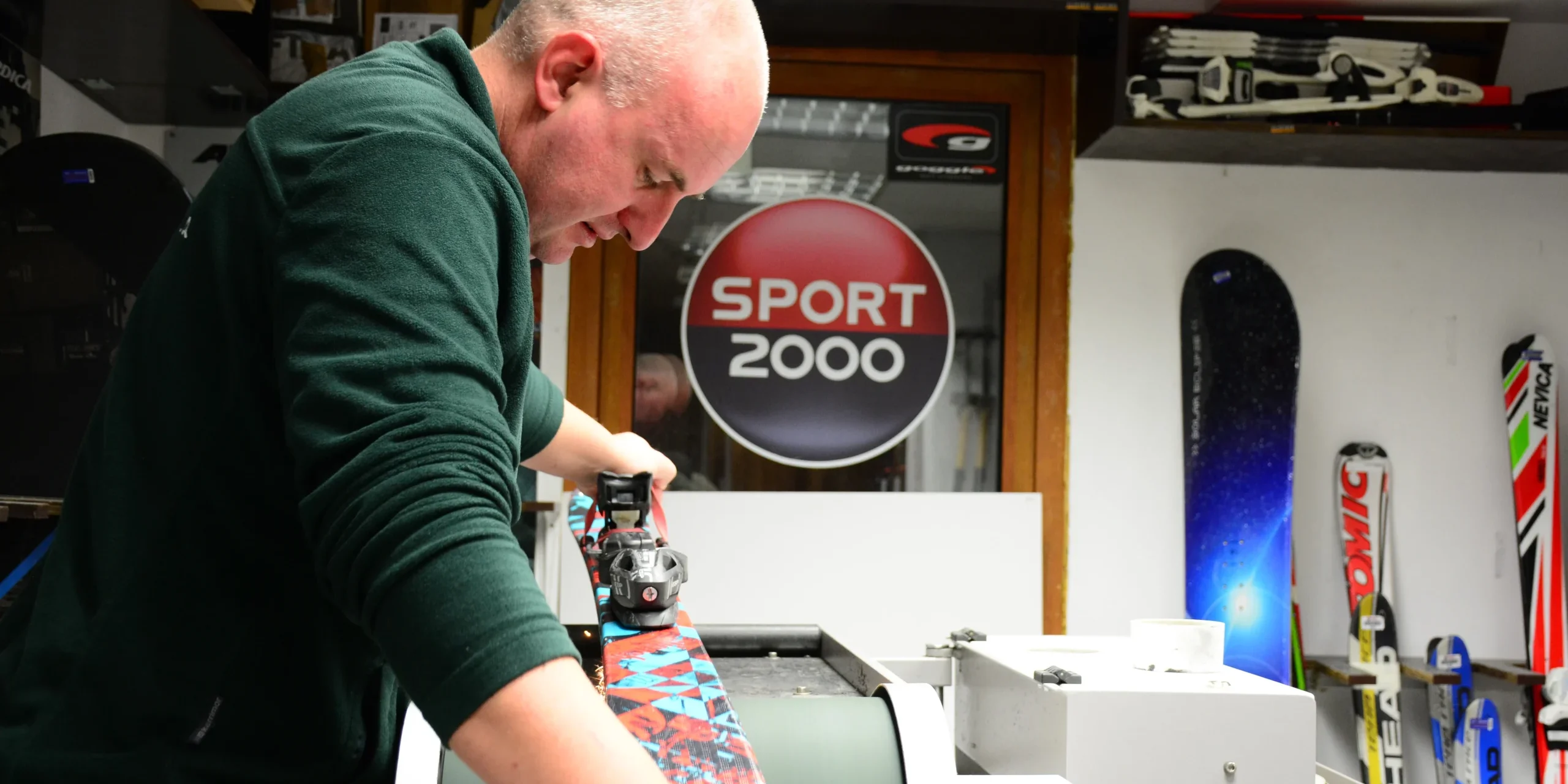 Technician tuning skis at Ski and Board Traventuria service center in Bansko
