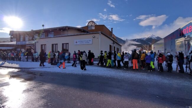 Early morning gondola queue at the bottom station in Bansko during peak February season